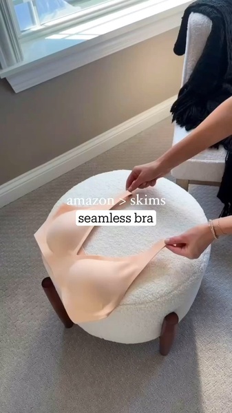 A high-contrast, minimalist comparison ad showcasing a seamless bra on a neutral stool, using direct text overlays to challenge market leaders.